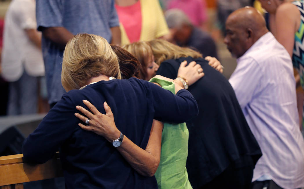 People embrace during a service at the First United Methodist Church in Coral Springs, Fla., on Sunday, Feb. 18, 2018. The service was dedicated to the victims of Wednesday's mass shooting at near ...