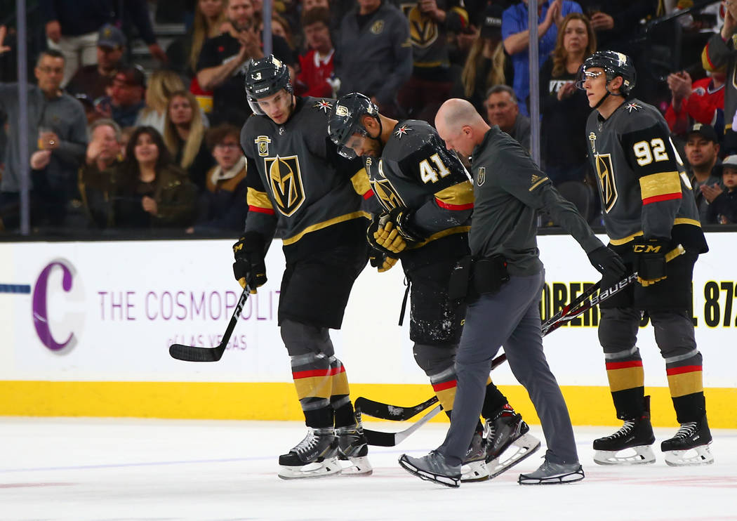 Golden Knights left wing Pierre-Edouard Bellemare (41) is escorted off the ice after a hard collision during the first period of an NHL hockey game against the Montreal Canadiens at T-Mobile Arena ...