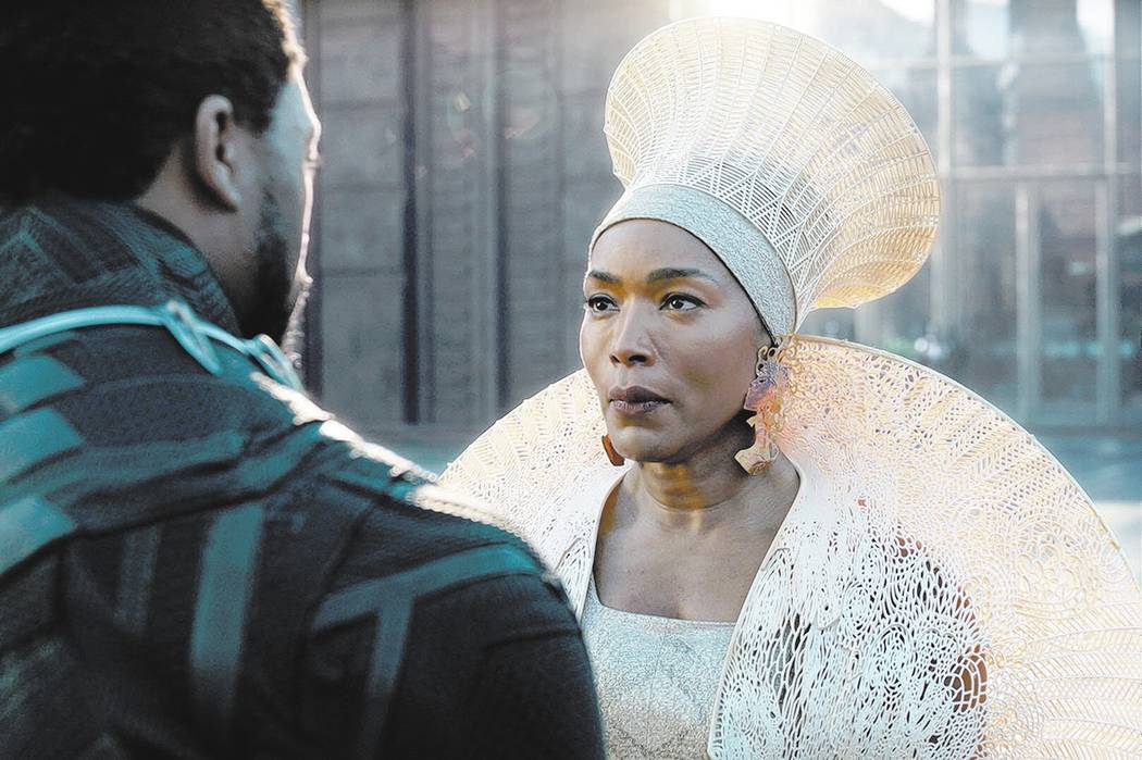 This image released by Disney -Marvel Studios shows Chadwick Boseman, left, and Angela Bassett in a scene from "Black Panther."  (Disney/Marvel Studios via AP)
