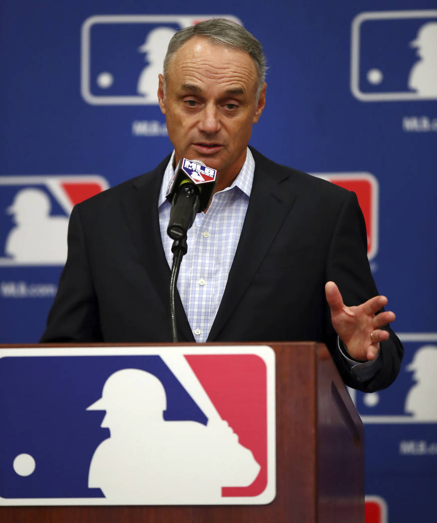 Baseball Commissioner Rob Manfred gestures while speaking during a Major League Baseball owners meeting on Tuesday, Feb. 20, 2018 in Glendale, Ariz. (AP Photo/Ben Margot)