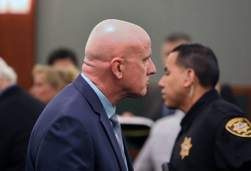 Las Vegas police Lt. James Melton leaves the courtroom at the Regional Justice Center on Wednesday, Feb. 21, 2018, in Las Vegas. Melton faces 14 felony counts, including theft, grand larceny auto, ...