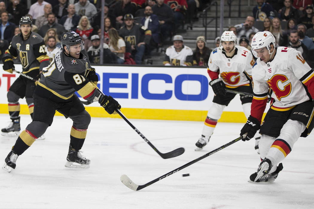 Vegas Golden Knights center Jonathan Marchessault (81) shoots the puck against Calgary Flames center Mikael Backlund (11) during the first period of an NHL game  at T-Mobile Arena in Las Vegas, We ...