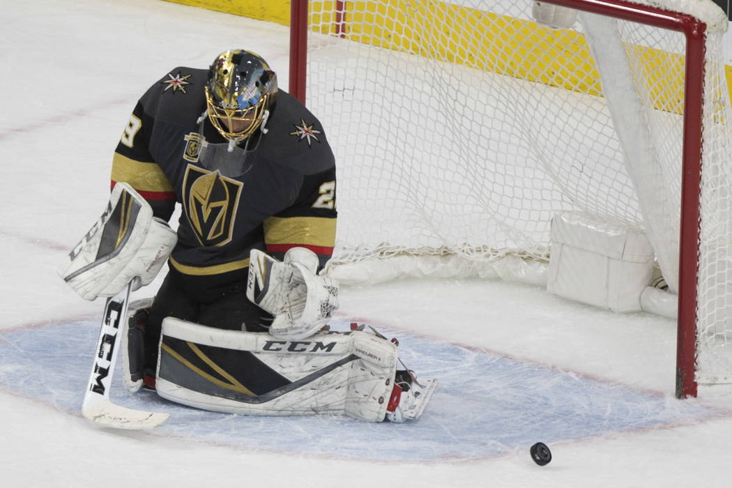 Vegas Golden Knights goaltender Marc-Andre Fleury (29) deflects a shot against Calgary Flames during the second period of an NHL hockey game at T-Mobile Arena in Las Vegas, Wednesday, Feb. 21, 201 ...