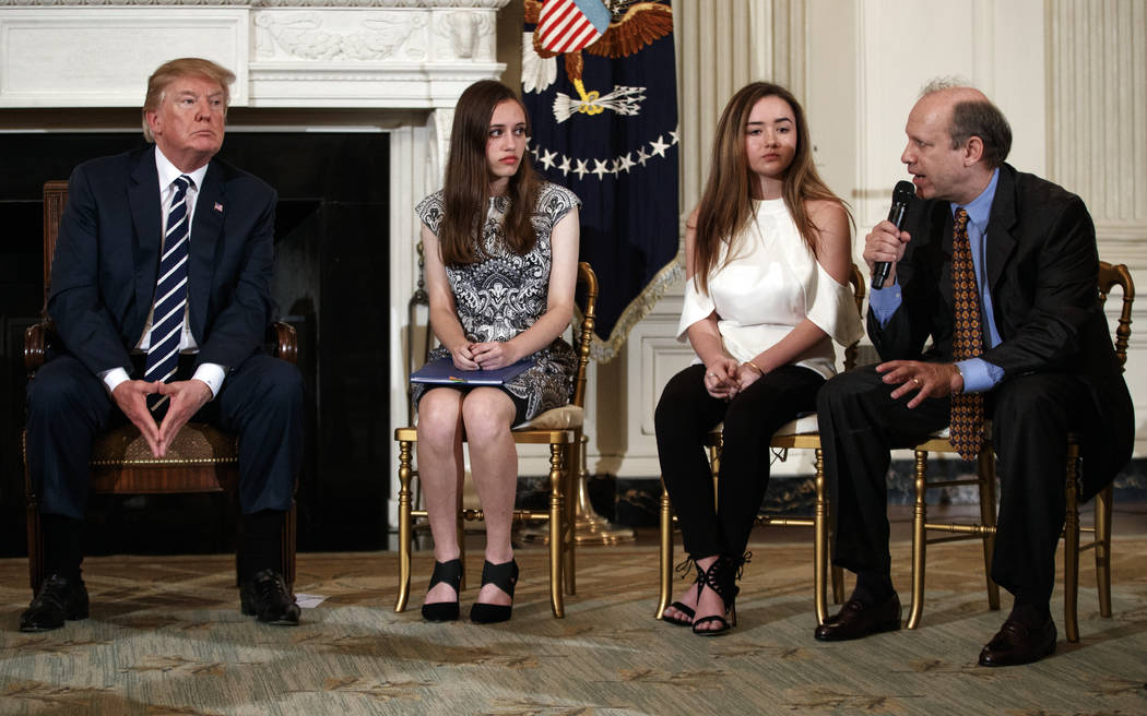 From left, President Donald Trump, Marjory Stoneman Douglas High School student students Carson Abt, and Ariana Klein, listen as Carson's father Frederick Abt, speaks during a listening session wi ...