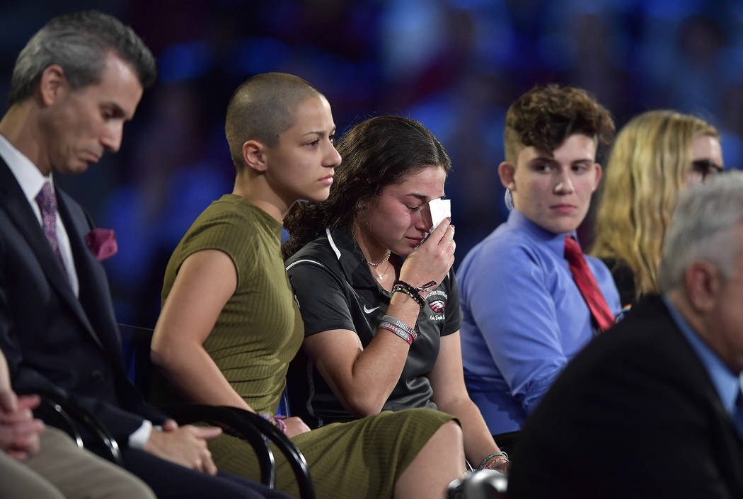Marjory Stoneman Douglas High School student Emma Gonzalez comforts a classmate during a CNN town hall meeting, Wednesday, Feb. 21, 2018, at the BB&T Center, in Sunrise, Fla. (Michael Laughlin ...
