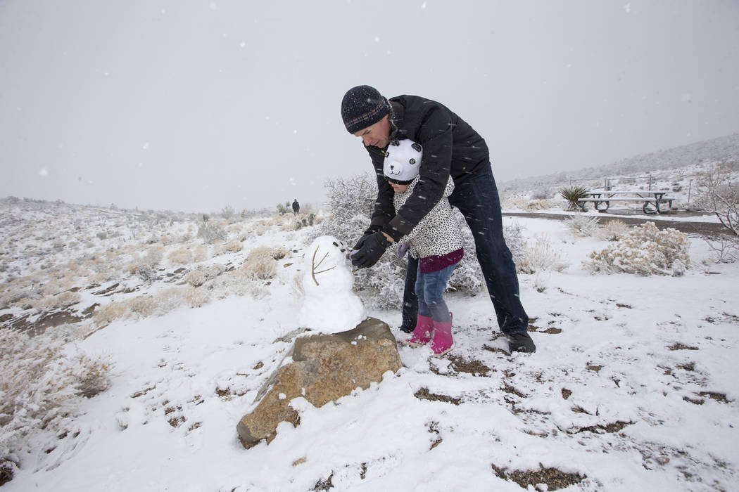 Danny Vasquez of Las Vegas and his daughter Nika, 4, play in the snow at Red Rock Canyon Overlook, Friday, Feb. 23, 2018 near Las Vegas. Richard Brian Las Vegas Review-Journal @vegasphotograph
