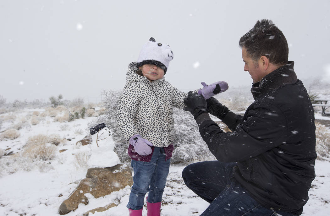 Danny Vasquez of Las Vegas and his daughter Nika, 4, play in the snow at Red Rock Canyon Overlook, Friday, Feb. 23, 2018 near Las Vegas. Richard Brian Las Vegas Review-Journal @vegasphotograph