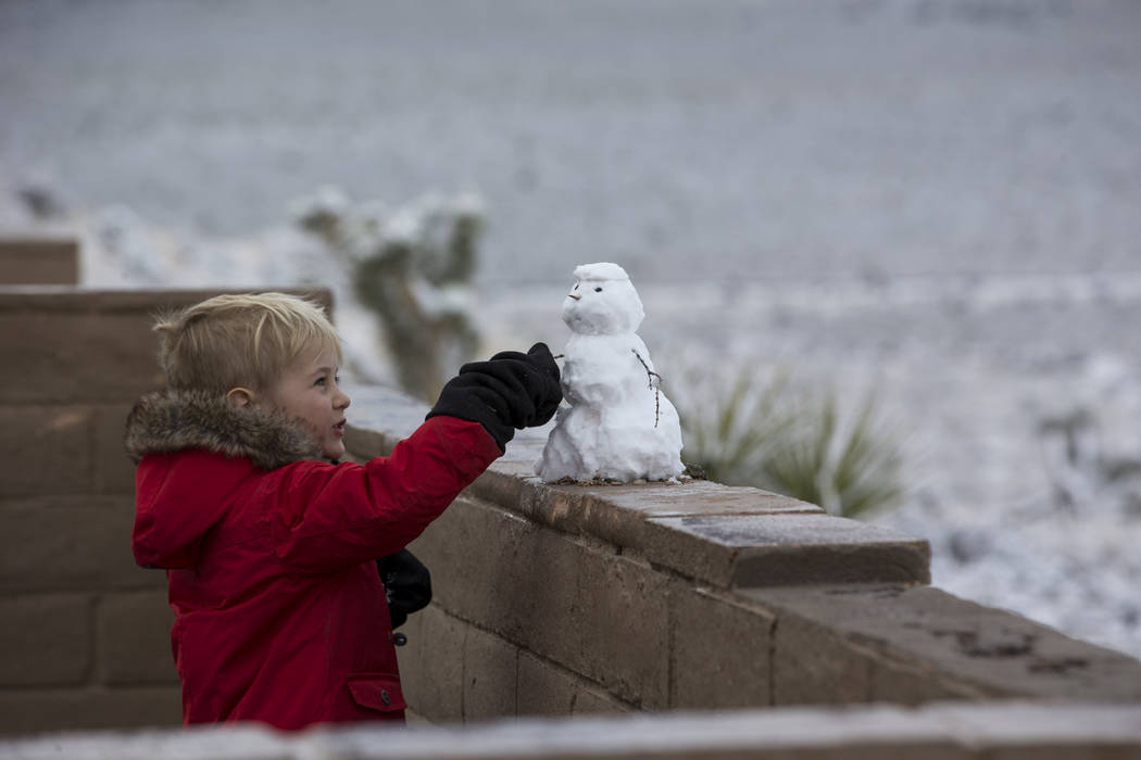 A boy looks at a snowman at Red Rock Canyon Overlook on Friday, Feb. 23, 2018. Richard Brian Las Vegas Review-Journal @vegasphotograph