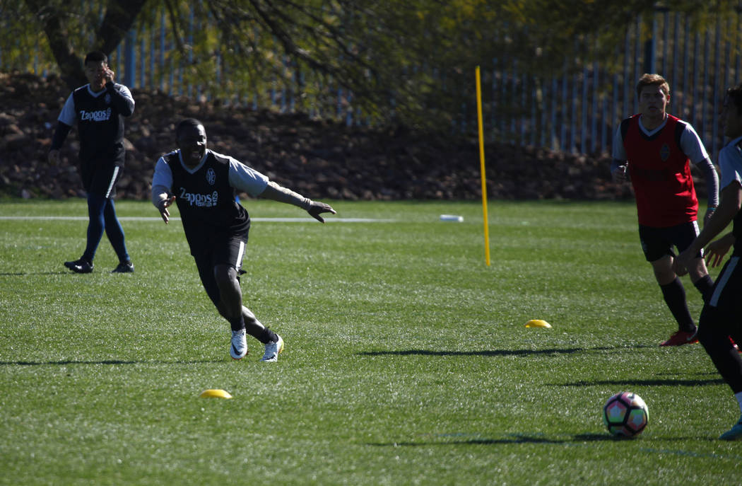 Former American soccer prodigy and U.S. national team member Freddy Adu, white shoes, runs toward the soccer ball as he tries out for the Las Vegas Lights FC at the team's practice field in Las Ve ...