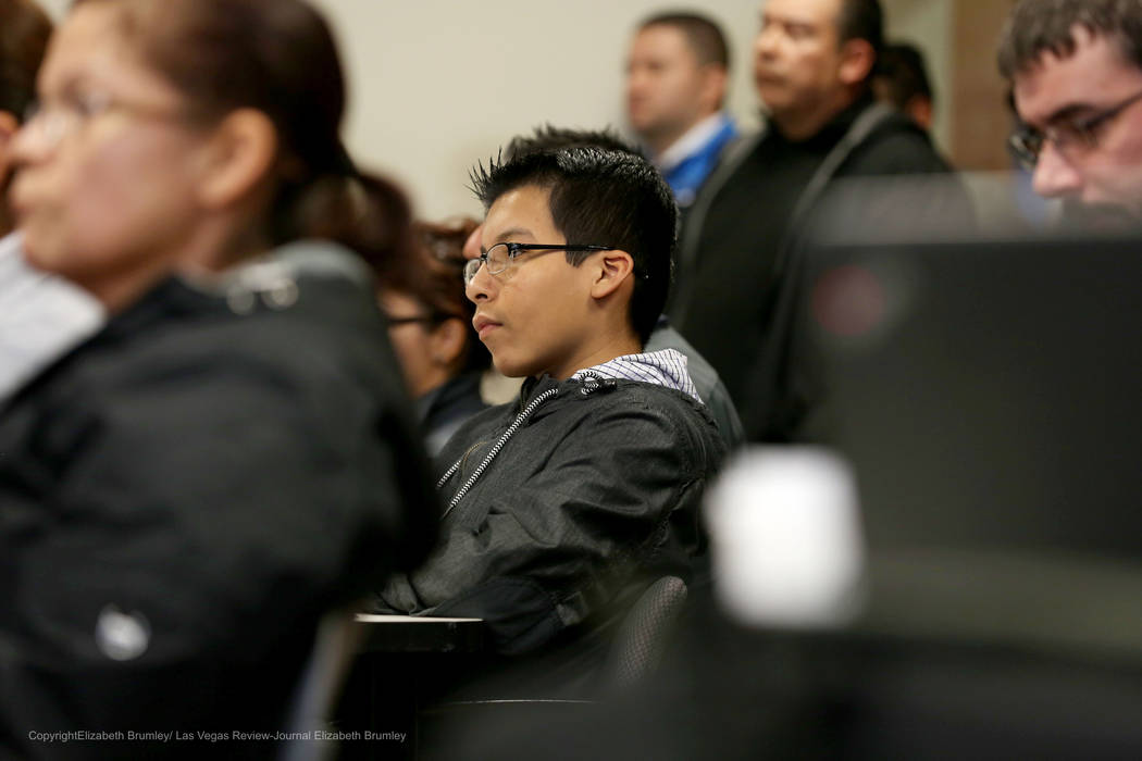 Erick Ruiz, a ninth grade student at Odyssey Charter High School, sits after sharing his opinion against transgender policies for the Clark County School District at Nevada Department of Educatio ...