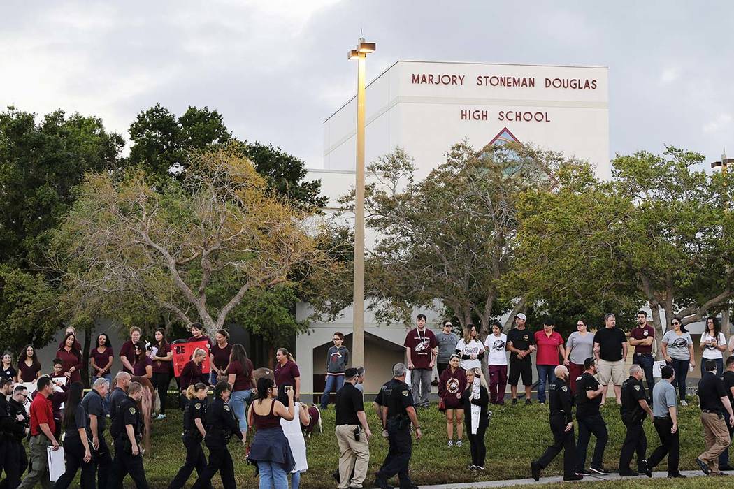 Police walk outside Marjory Stoneman Douglas High School in Parkland, Florida, Wednesday, Feb. 28, 2018. Students returned to class for the first time since 17 people were killed. (Terry Renna/AP)