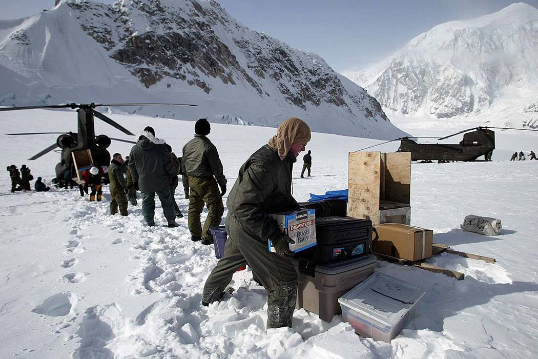 In this April 15, 2002, file photo, members of the U.S. Army's High Altitude Rescue Team from Fort Wainwright Army Base near Fairbanks, Alaska, unload supplies from the team's CH-47 Chinook helico ...
