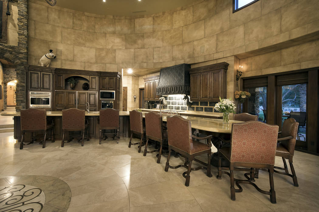 The kitchen has a large island for seating. (Synergy/Sotheby’s International Realty)