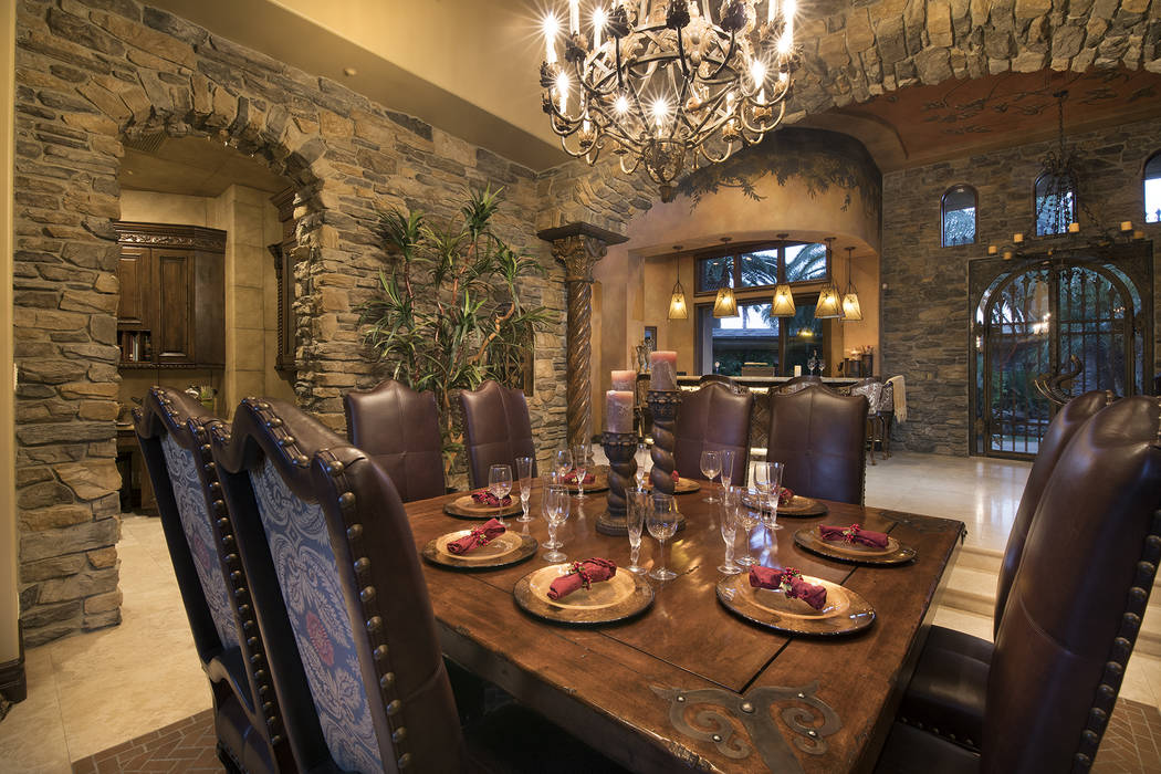 The home's formal dining room is off the entrance to the pool. (Synergy/Sotheby’s International Realty)