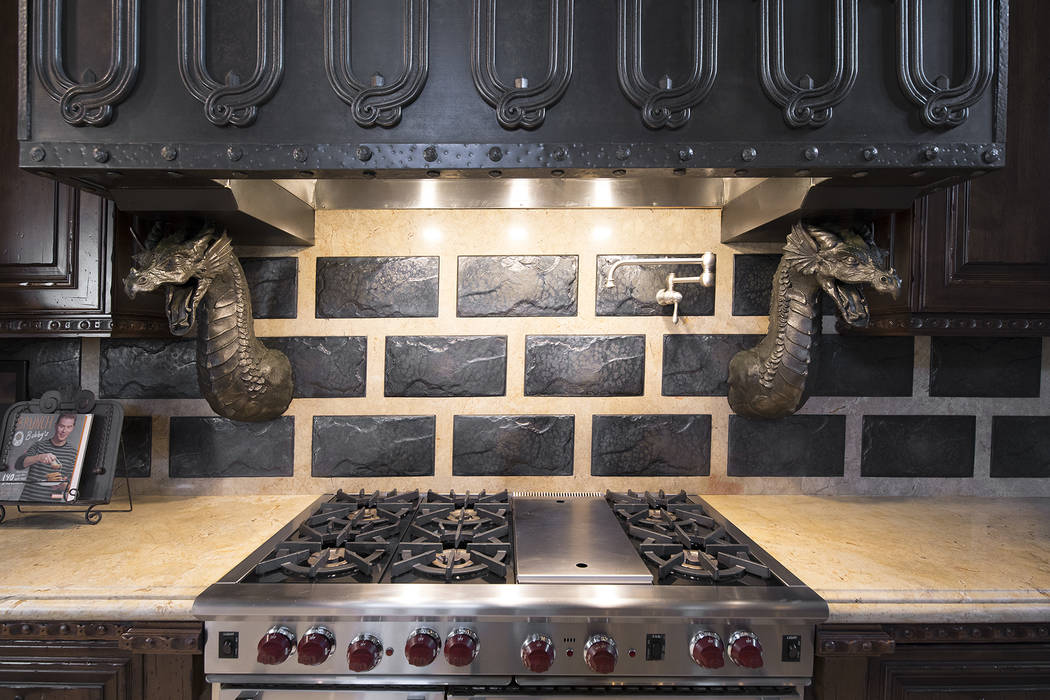 Lava tiles and dragons are above the stove in the kitchen. (Synergy/Sotheby’s International Realty)
