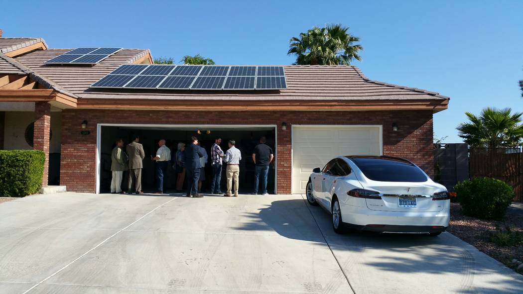 A homeowner uses photovoltaic solar panels to generate electric power for both his residential home and a Tesla Model S electric car. (Stan Hanel RJNewHomes.Vegas)