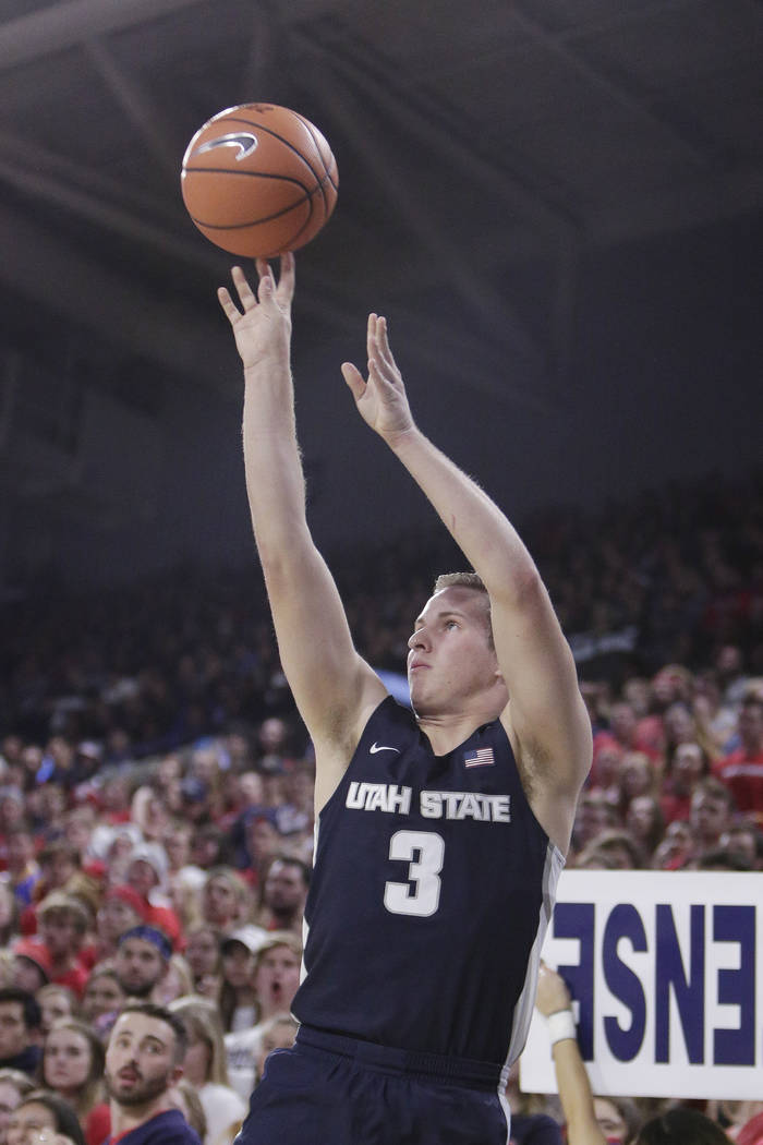 Utah State guard Sam Merrill (3) shoots during the first half of an NCAA college basketball game against Gonzaga in Spokane, Wash., Saturday, Nov. 18, 2017. (AP Photo/Young Kwak)