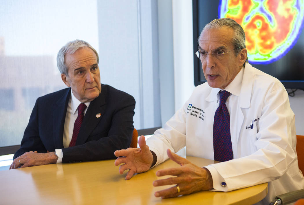 Dr. Jeffrey Cummings, outgoing director of the Cleveland Clinic Lou Ruvo Center for Brain Health, right, talks about the incoming director, Dr. Marwan Sabbagh, not pictured, next to Larry Ruvo, fo ...