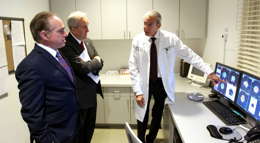 Secretary of Veteran's Affairs David Shulkin, left, gets a tour of the Lou Ruvo Center for Brain Health, Cleveland Clinic in Las Vegas from founder Larry Ruvo, center, and Director Dr. Jeffrey Cum ...
