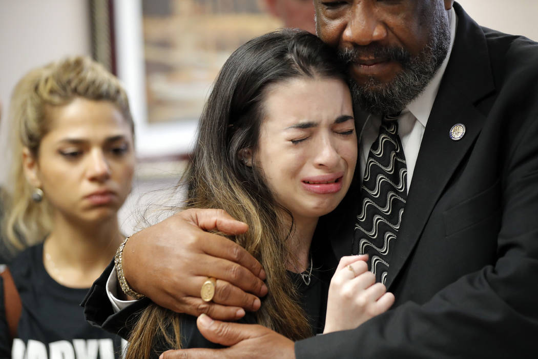 Aria Siccone, 14, a 9th grade student survivor from Marjory Stoneman Douglas High School, where more than a dozen students and faculty were killed in a mass shooting on Wednesday, cries as she rec ...