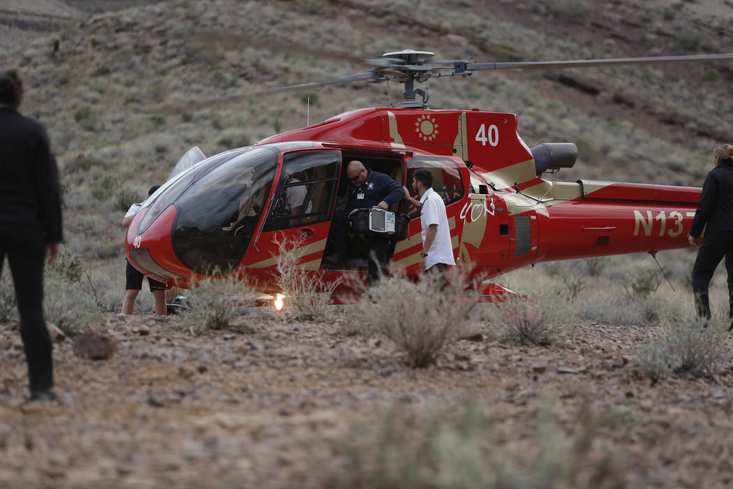 Emergency personnel arrive at the scene of a deadly tour helicopter crash in the Grand Canyon, Arizona, Saturday, Feb. 10, 2018. The crash killed three people and injured four others.  Photo by Te ...