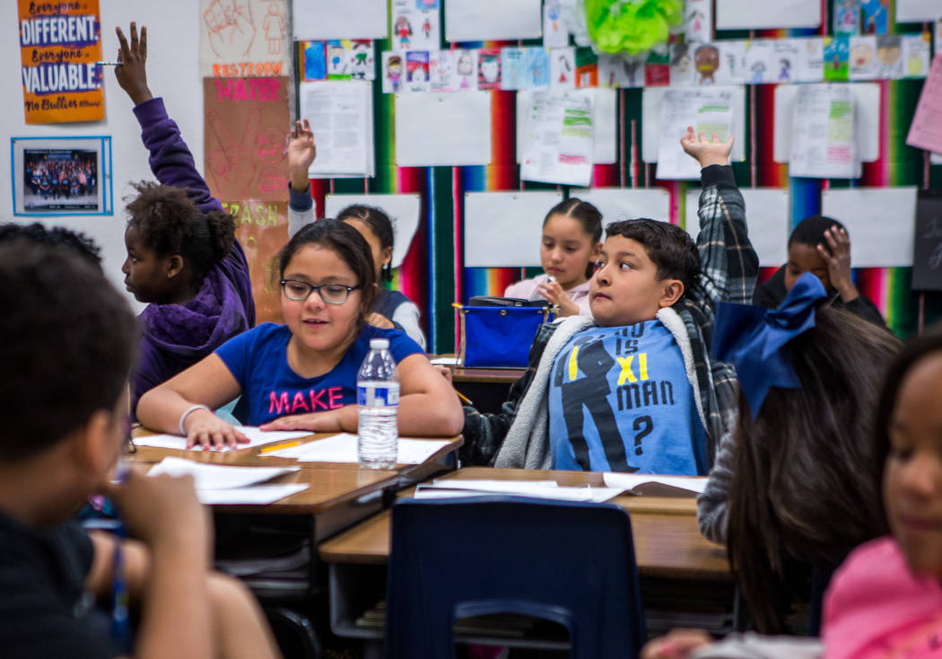 Ricardo Martinez, center right, raises his hand with Yaritzel Rios-Perez next to him in Ms. Garcia's fourth grade class at H. P. Fitzgerald Elementary School in North Las Vegas on Tuesday, March 6 ...