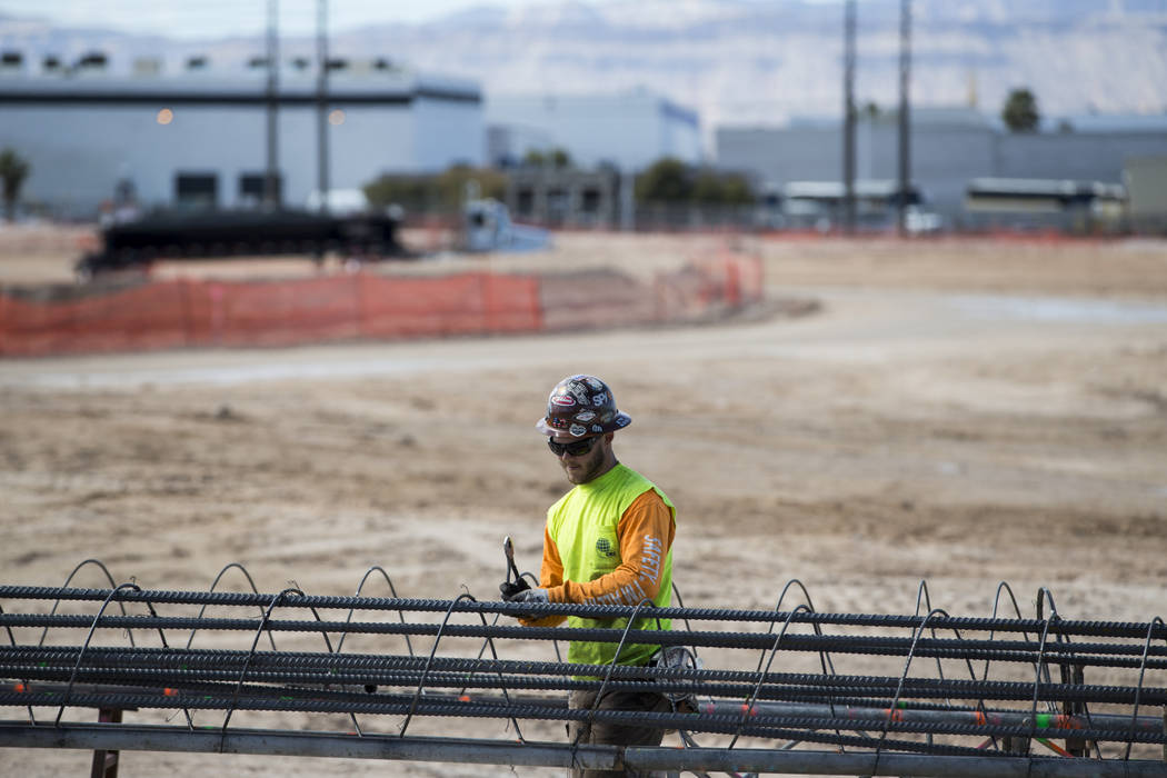 A worker handles steel rods at the future Raiders stadium site in Las Vegas, Tuesday, March 6, 2018. (Erik Verduzco/Las Vegas Review-Journal) @Erik_Verduzco