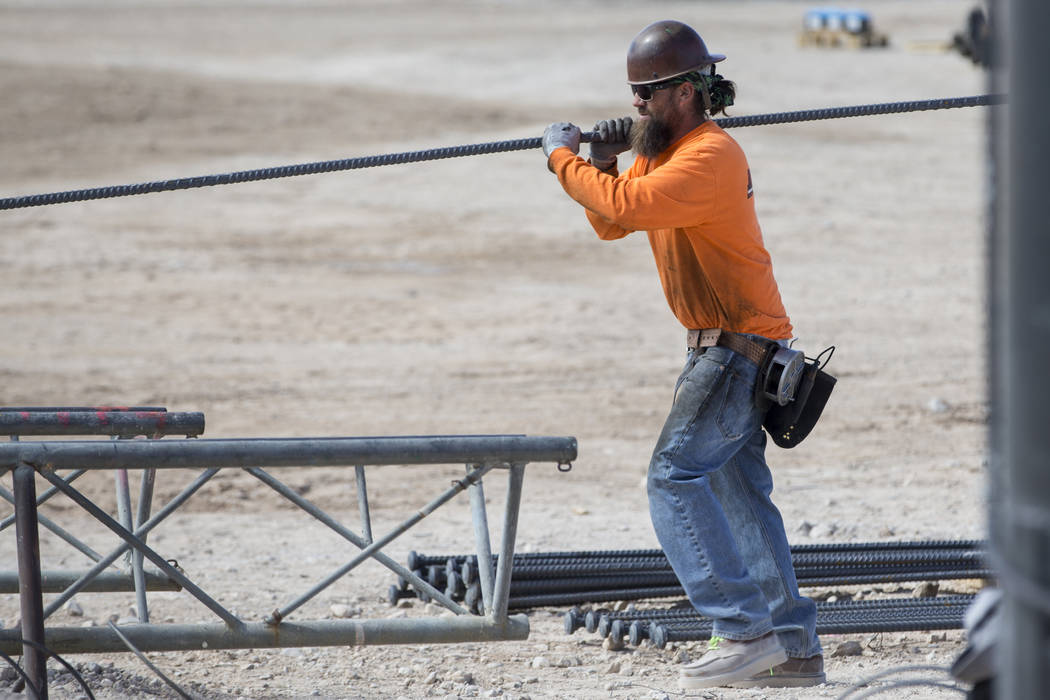 A worker handles steel rod at the future Raiders stadium site in Las Vegas, Tuesday, March 6, 2018. (Erik Verduzco/Las Vegas Review-Journal) @Erik_Verduzco