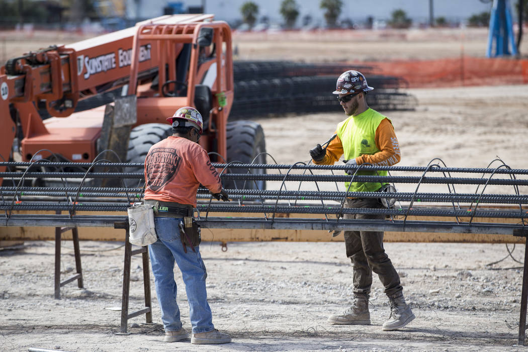 Workers handle steel rods at the future Raiders stadium site in Las Vegas, Tuesday, March 6, 2018. (Erik Verduzco/Las Vegas Review-Journal) @Erik_Verduzco