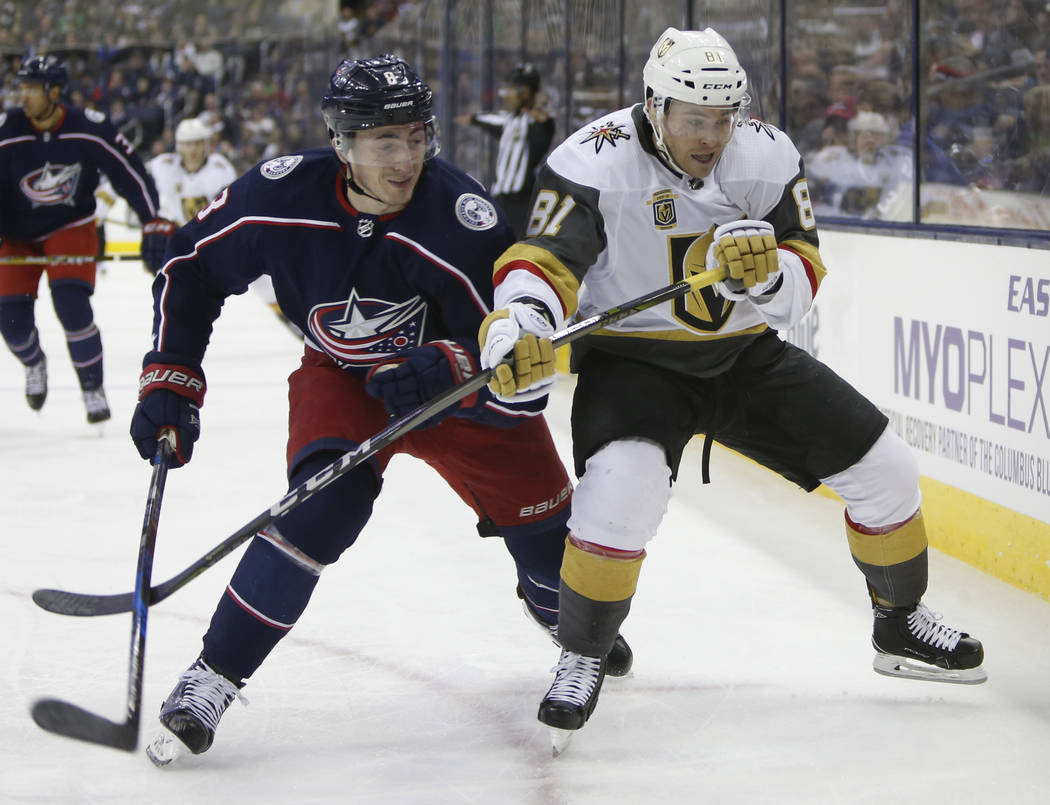 Columbus Blue Jackets' Zach Werenski, left, and Las Vegas Golden Knights' Jonathan Marchessault fight for position during the first period of an NHL hockey game Tuesday, March 6, 2018, in Columbus ...