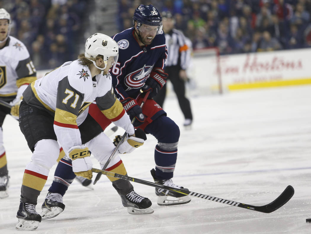 Las Vegas Golden Knights' William Karlsson, left, of Sweden, and Columbus Blue Jackets' Thomas Vanek, of Austria, chase the puck during the first period of an NHL hockey game Tuesday, March 6, 201 ...