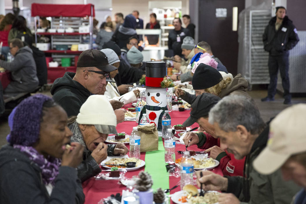 Guests eat Christmas dinner at Catholic Charities of Southern Nevada on Monday, Dec. 25, 2017, in Las Vegas. More than 100 volunteers served approximately 1000 Christmas meals to Sourthern Nevada' ...