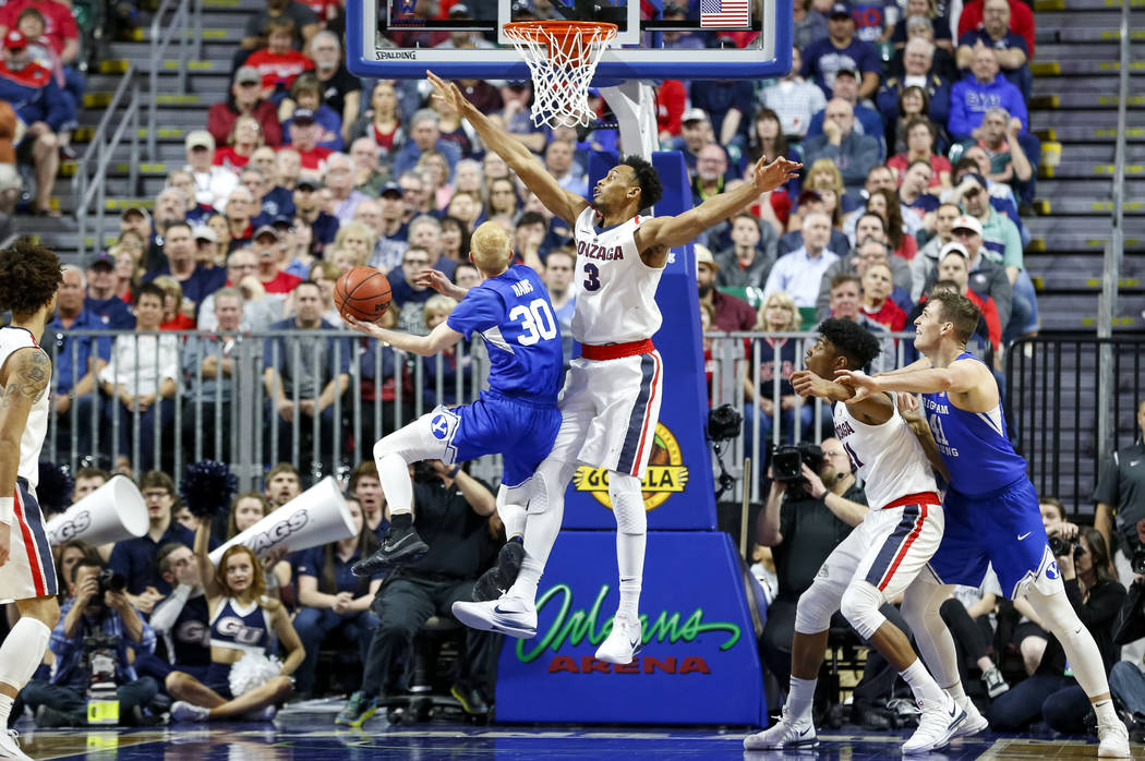 Brigham Young Cougars guard TJ Haws (30) attempts a shot as Gonzaga Bulldogs forward Johnathan Williams (3) goes in for the block during the West Coast Conference championship game at the Orleans  ...