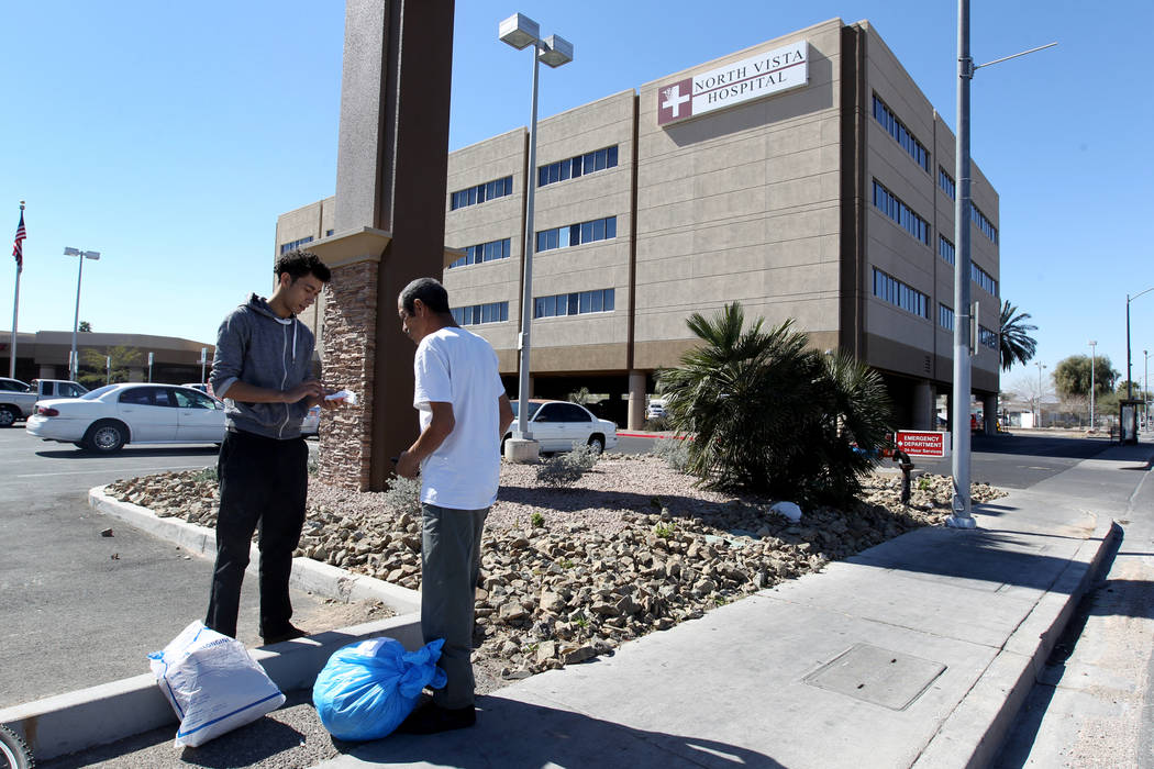 Carlos Sanchez, 61, right, gets help gathering his belongings from his son, Jacob Edward Delgado, 23, after being released from North Vista Hospital's psychiatric ward Friday, March 9, 2018. K.M.  ...