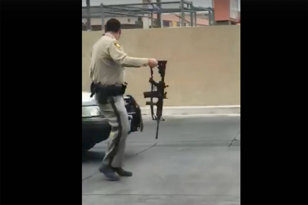 Images taken from a video by Steven Gibson of Las Vegas police arresting a man who was found unconscious in his car with a semi-automatic rifle and extra ammunition. (Steven Gibson/Facebook)