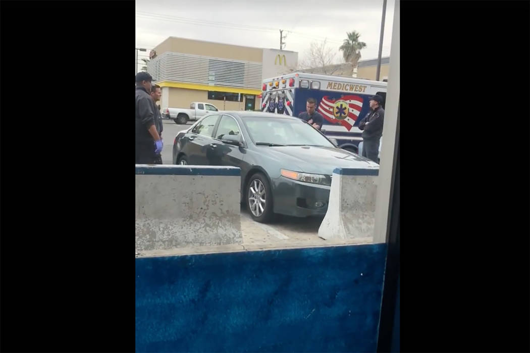 Images taken from a video by Steven Gibson of Las Vegas police arresting a man who was found unconscious in his car with a semi-automatic rifle and extra ammunition. (Steven Gibson/Facebook)