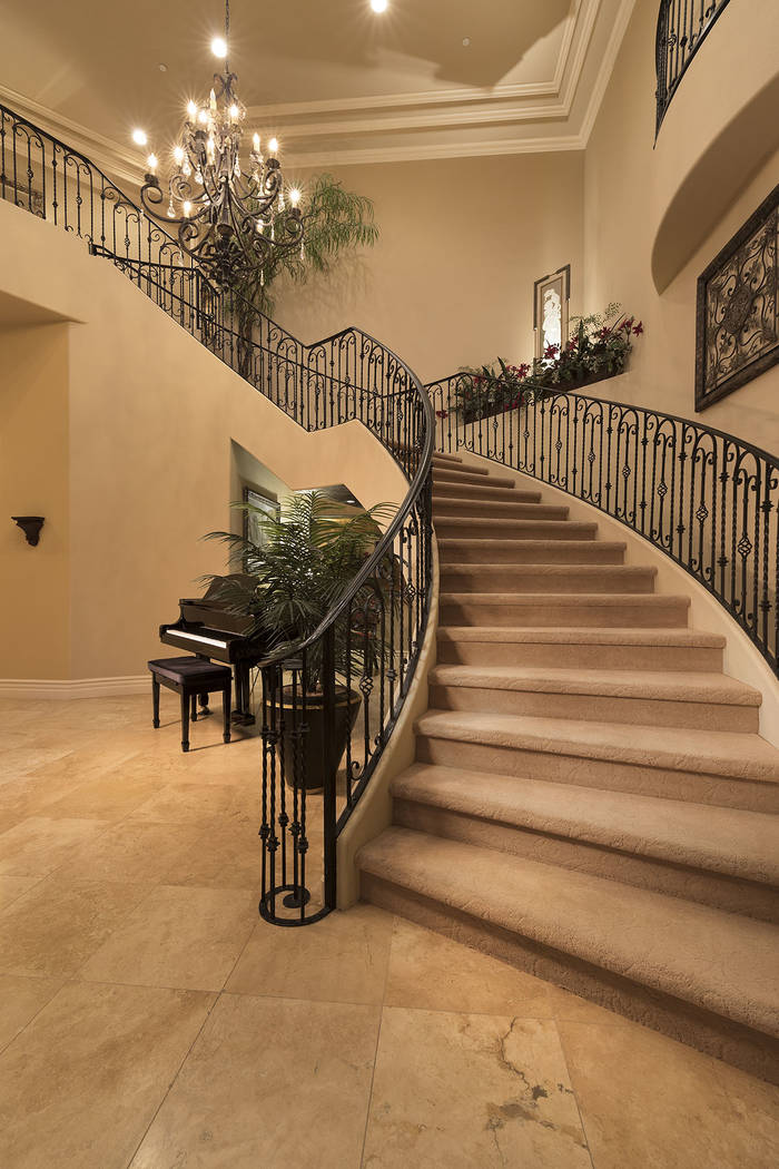 The grand staircase connects the two stories. (Synergy/Sotheby’s International Realty)