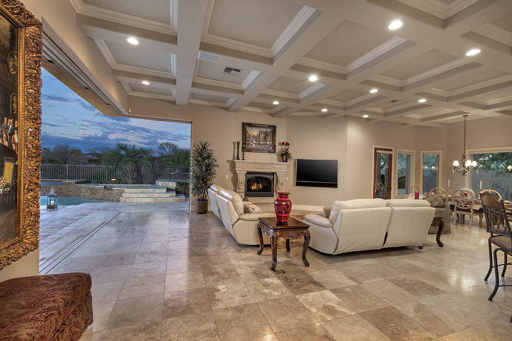 The living room opens to the spa and pool. (Synergy/Sotheby’s International Realty)