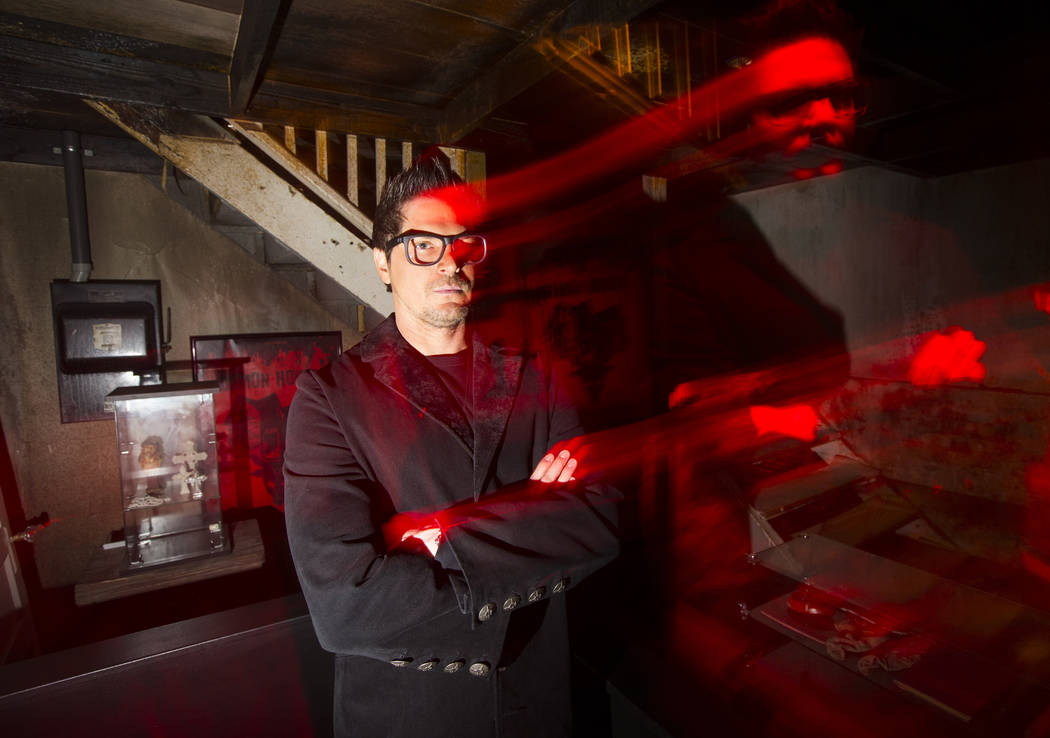 Zak Bagans, paranormal investigator and host of Travel Channel's "Ghost Adventures," poses for a photo in a room with items from his upcoming documentary "Demon House" at the H ...