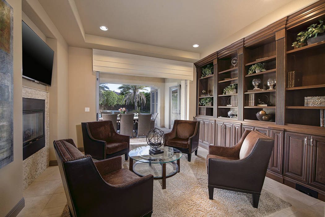 The library opens to the patio. (Synergy/Sotheby’s International Realty)