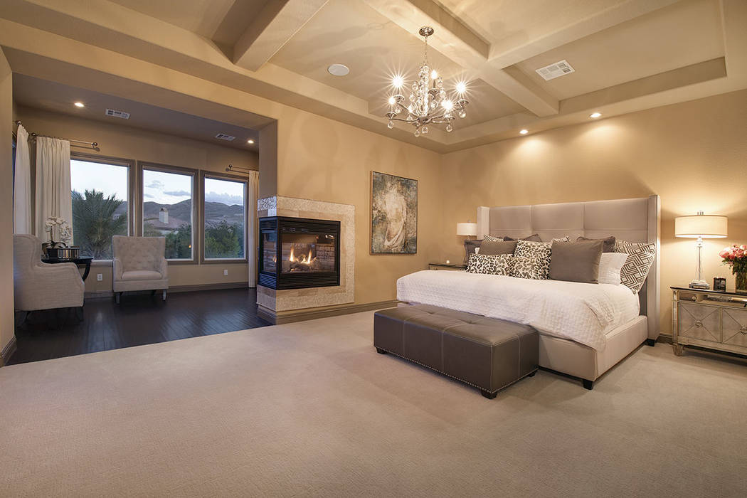 The master suite features a three-sided fireplace. (Synergy/Sotheby’s International Realty)