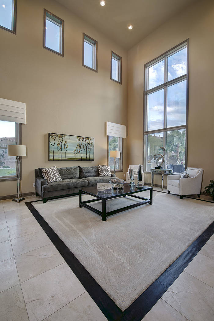 The family room features large windows and high ceilings. (Synergy/Sotheby’s International Realty)