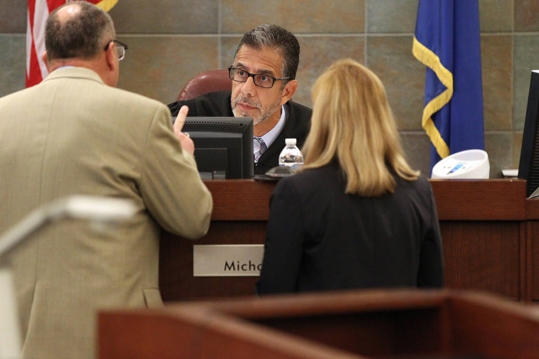 District Judge Michael Villani, center, talks to Deputy Public Defender Bryan Cox, left, and Deputy District Attorney Karen Mishler during sentencing for disbarred Las Vegas lawyer Easton Harris a ...