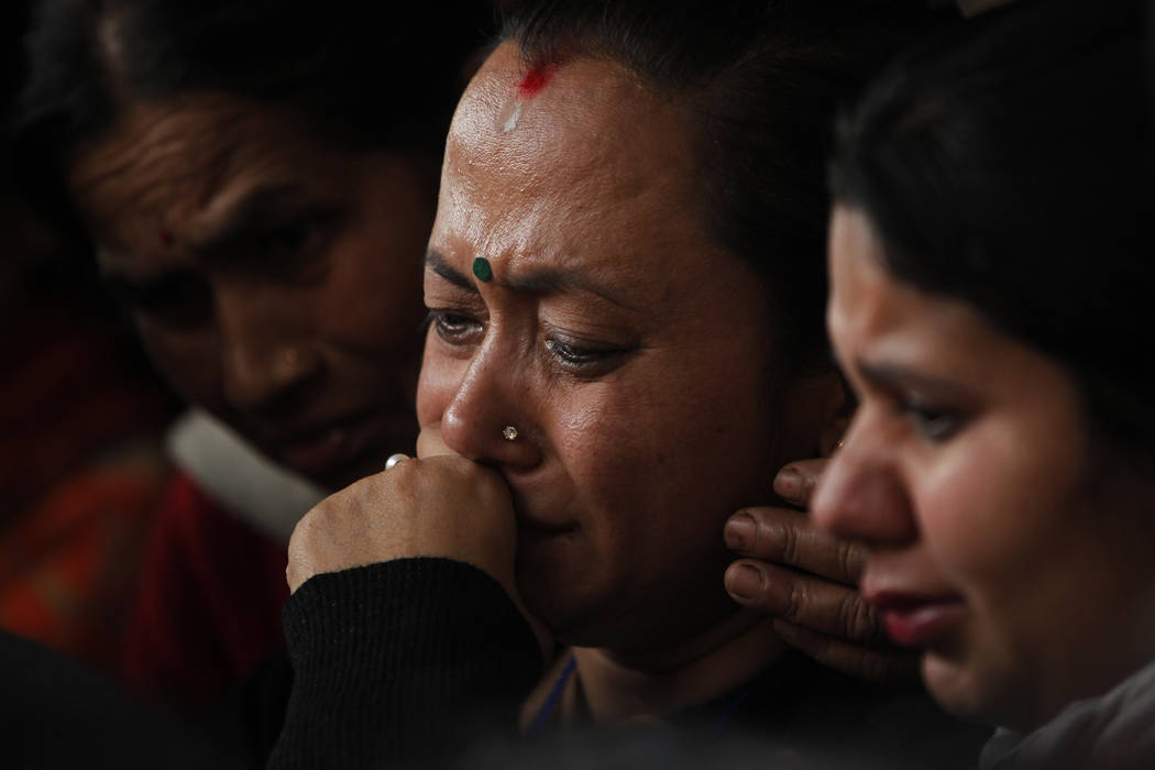 Unidentified family members of a passenger of a US-Bangla Flight BS211 mourn as they wait to receive his body outside government hospital in Kathmandu, Nepal, Tuesday, March 13, 2018AP Photo/Niran ...