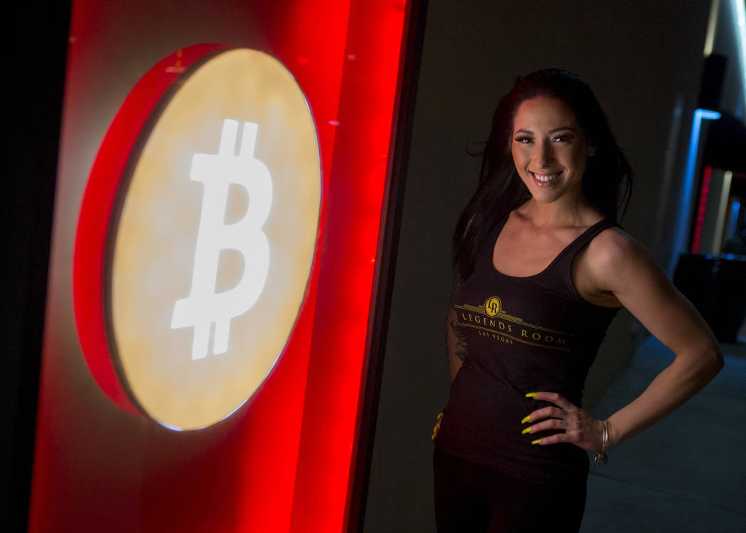 Bartender Deianna Lo next to the club's Bitcoin sign outside of the Legends Room in Las Vegas on Wednesday, March 21, 2018. Patrick Connolly Las Vegas Review-Journal @PConnPie