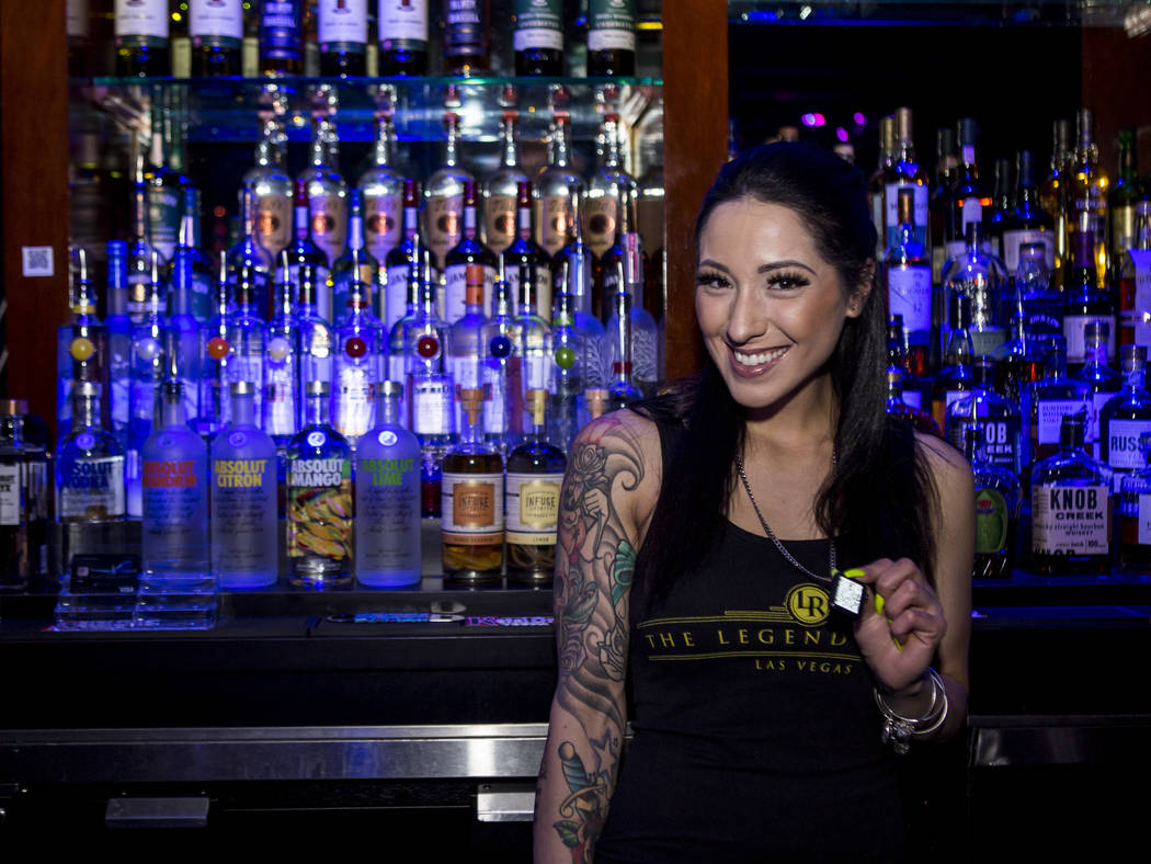 Bartender Deianna Lo shows off a QR code necklace that can be used to pay for drinks and services at the Legends Room in Las Vegas on Wednesday, March 21, 2018. Patrick Connolly Las Vegas Review-J ...