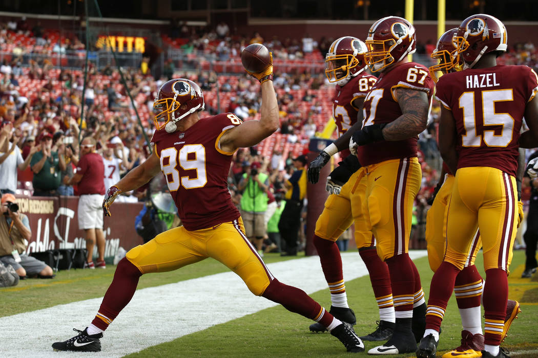 Washington Redskins tight end Derek Carrier (89) spikes the ball in front of teammates after scoring a touchdown in the second half of a preseason NFL football game against the Cincinnati Bengals, ...