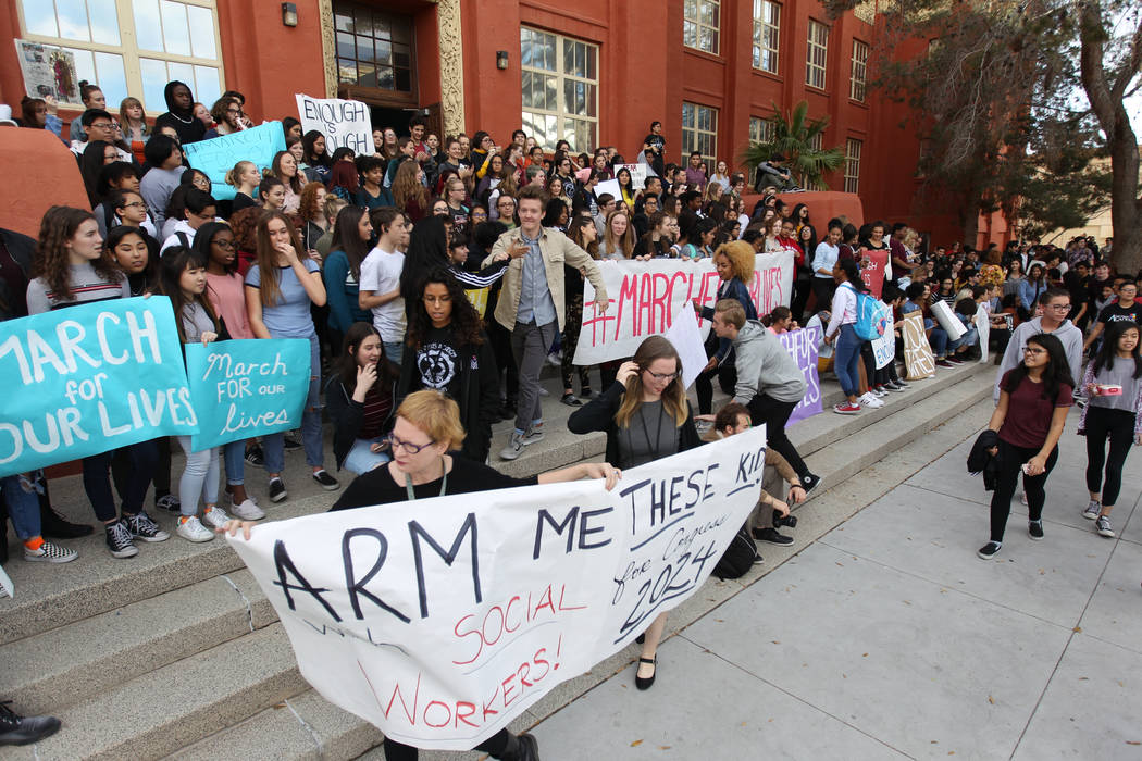 Students at Las Vegas Academy gather on the steps at the entrance to the school after walking out of class Wednesday, March 14, 2018, to mark the one-month anniversary of a shooting at a Florida s ...