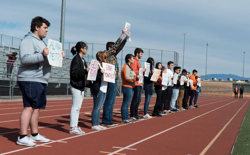 Students at Clark High School in Las Vegas hold up names of each of the 17 victims in the Parkland shooting during the national student walkout, March 14, 2018. (Marcus Villagran)