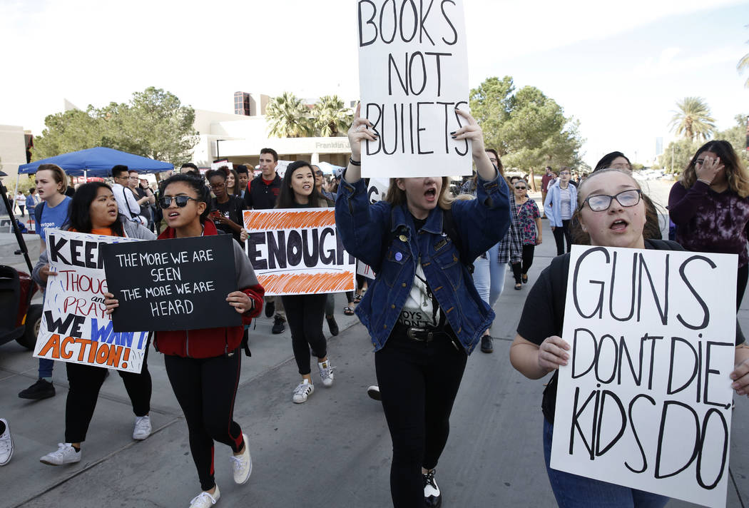 UNLV students, including Emily Bolshazy, right, shout slogans as they march at their campus in Las Vegas on Wednesday, March 14, 2018 as part of a nationwide protest against gun violence. Bizuayeh ...